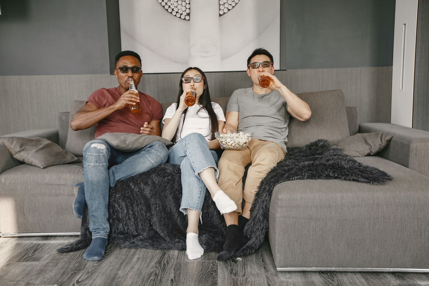 People with drinks and popcorn during a film night.