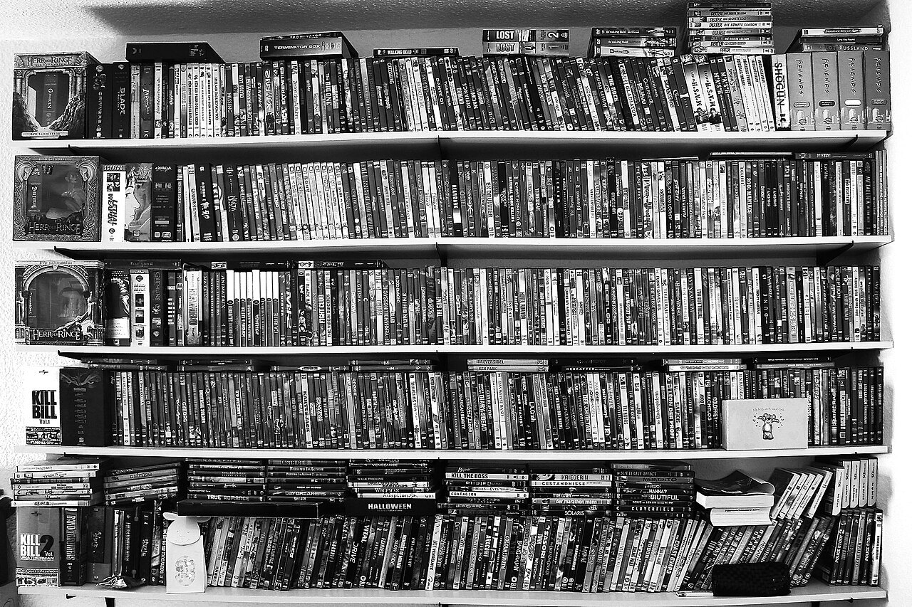 Film DVDs arranged on a shelf.