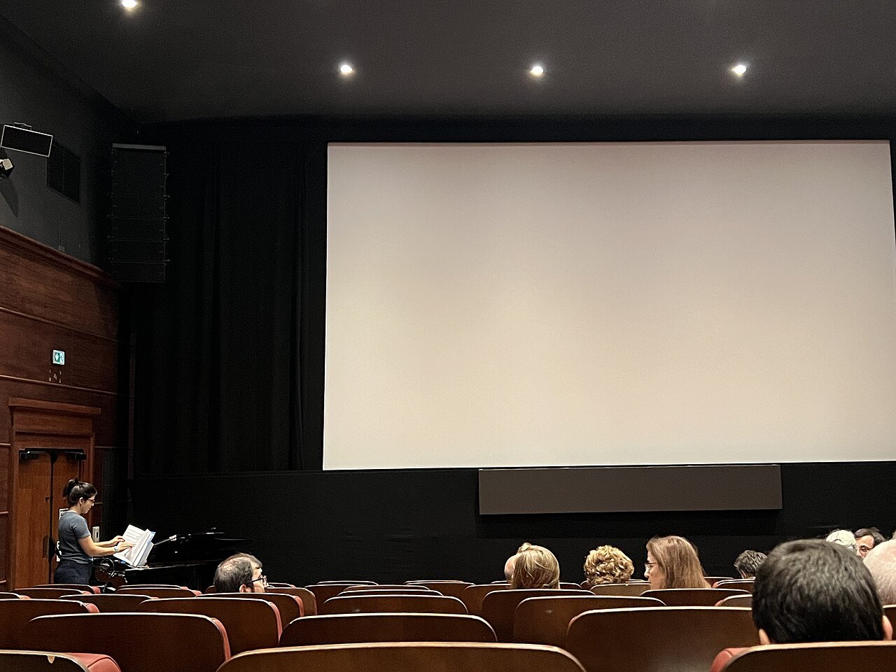 Cinema auditorium with a piano for musical accompaniment.