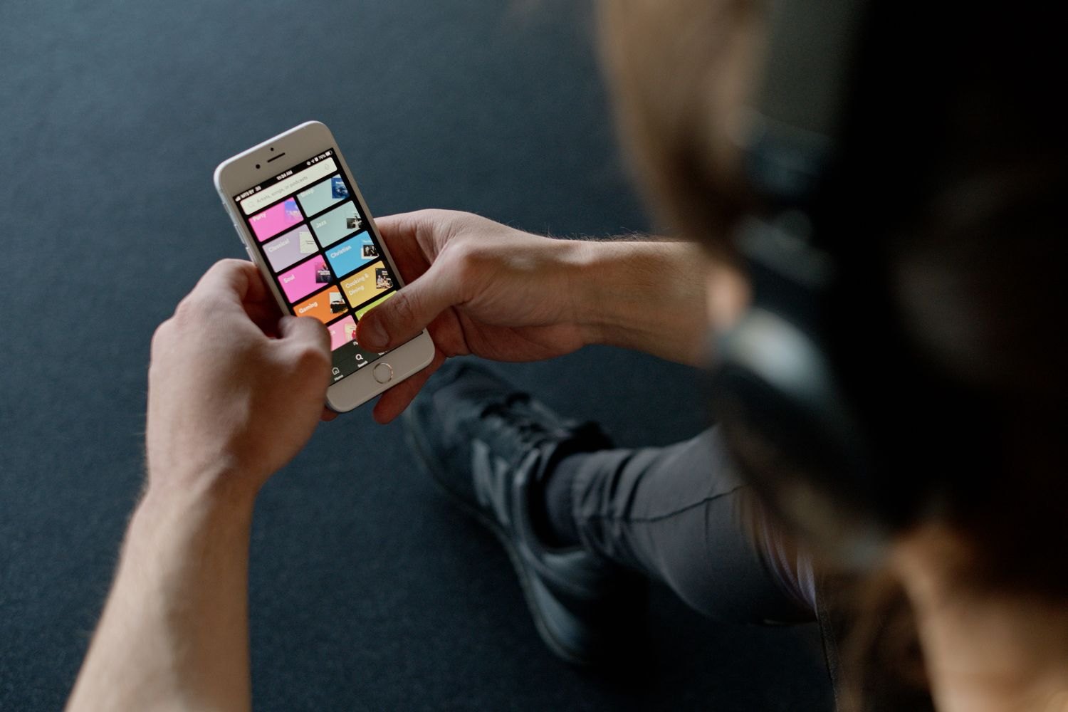 Music selection on a smartphone connected to headphones.