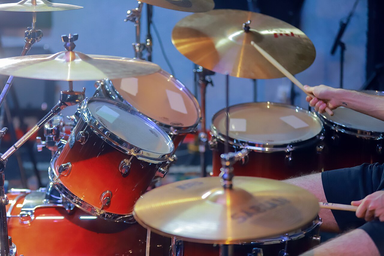 Drum kit with cymbals, toms and snare being played.