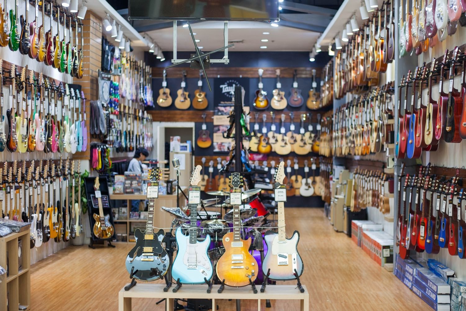 Different guitars displayed in an instrument shop.