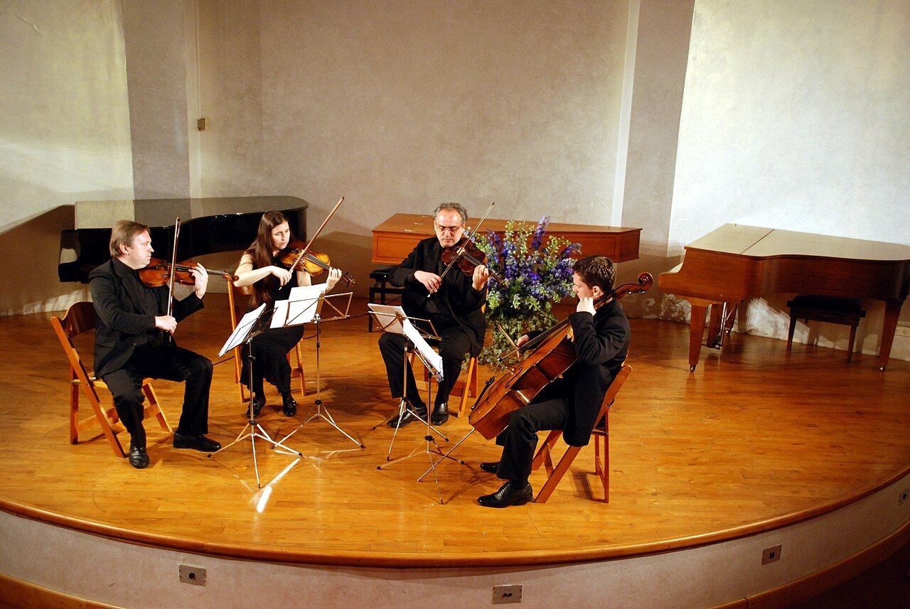 String quartet with music stands arranged for ensemble playing.