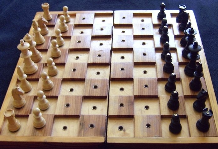 Tactile chessboard with raised squares and holes for pegged pieces.
