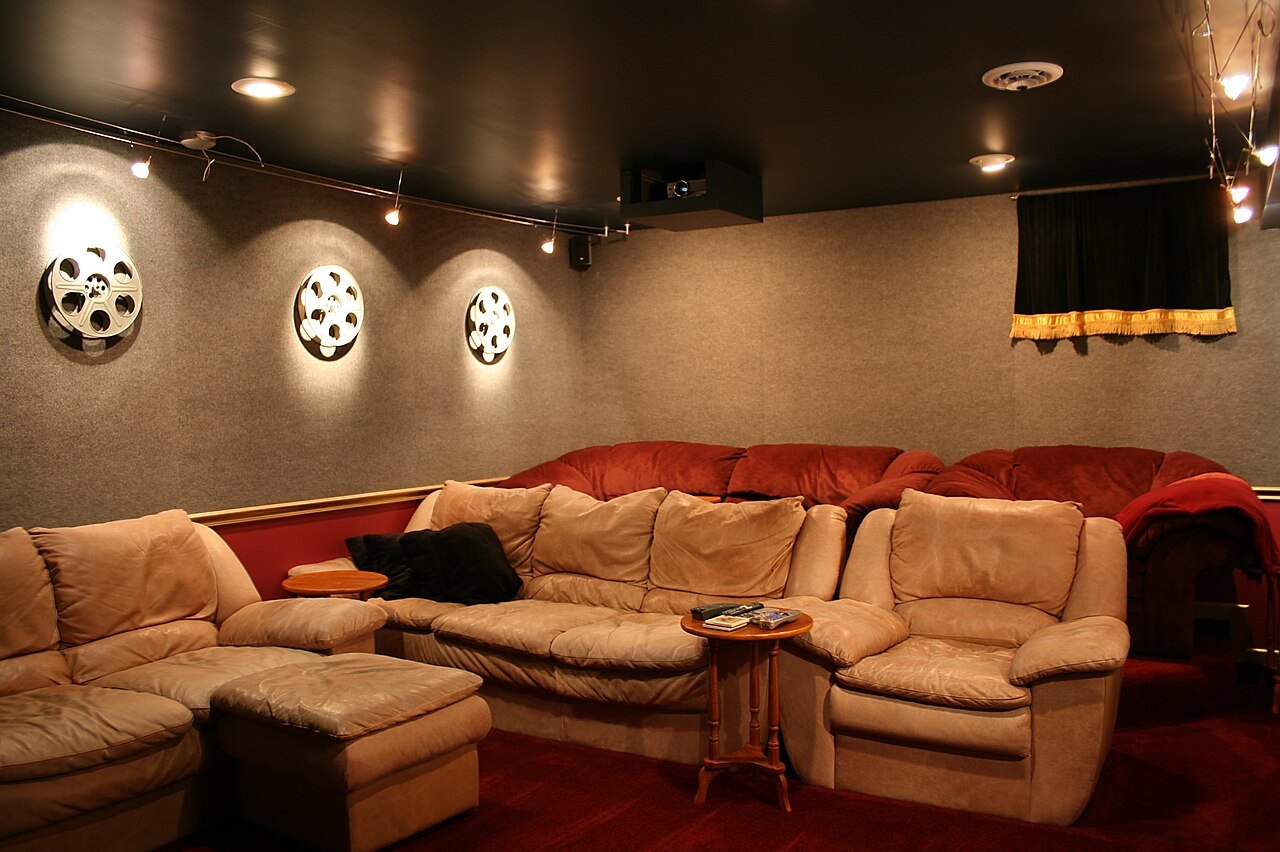 Home cinema room with several seats and subdued lighting.