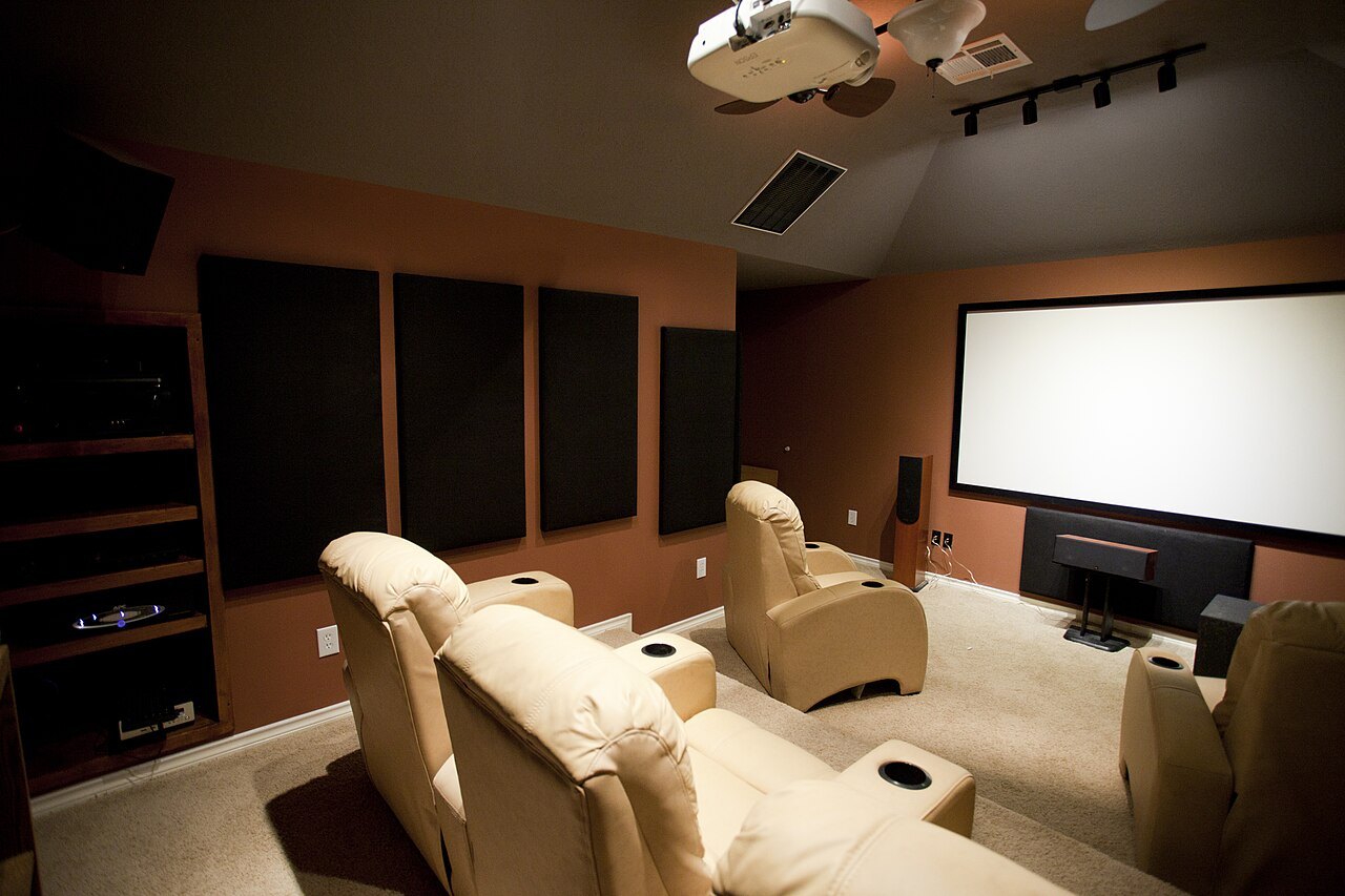 White projection screen in a furnished home cinema room.