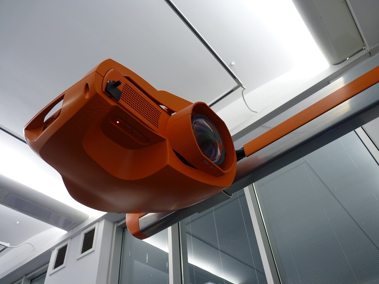 Projector mounted on an overhead rail.