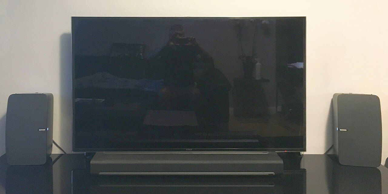 Television with a soundbar immediately below it.