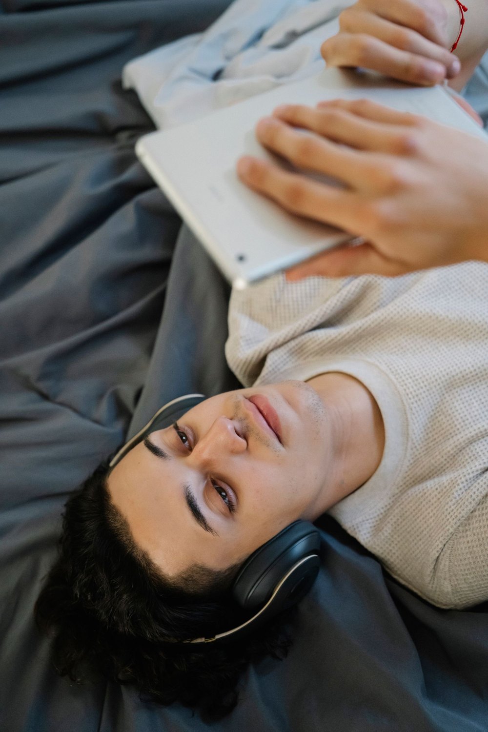 Headphones provide personal audio while watching a tablet.