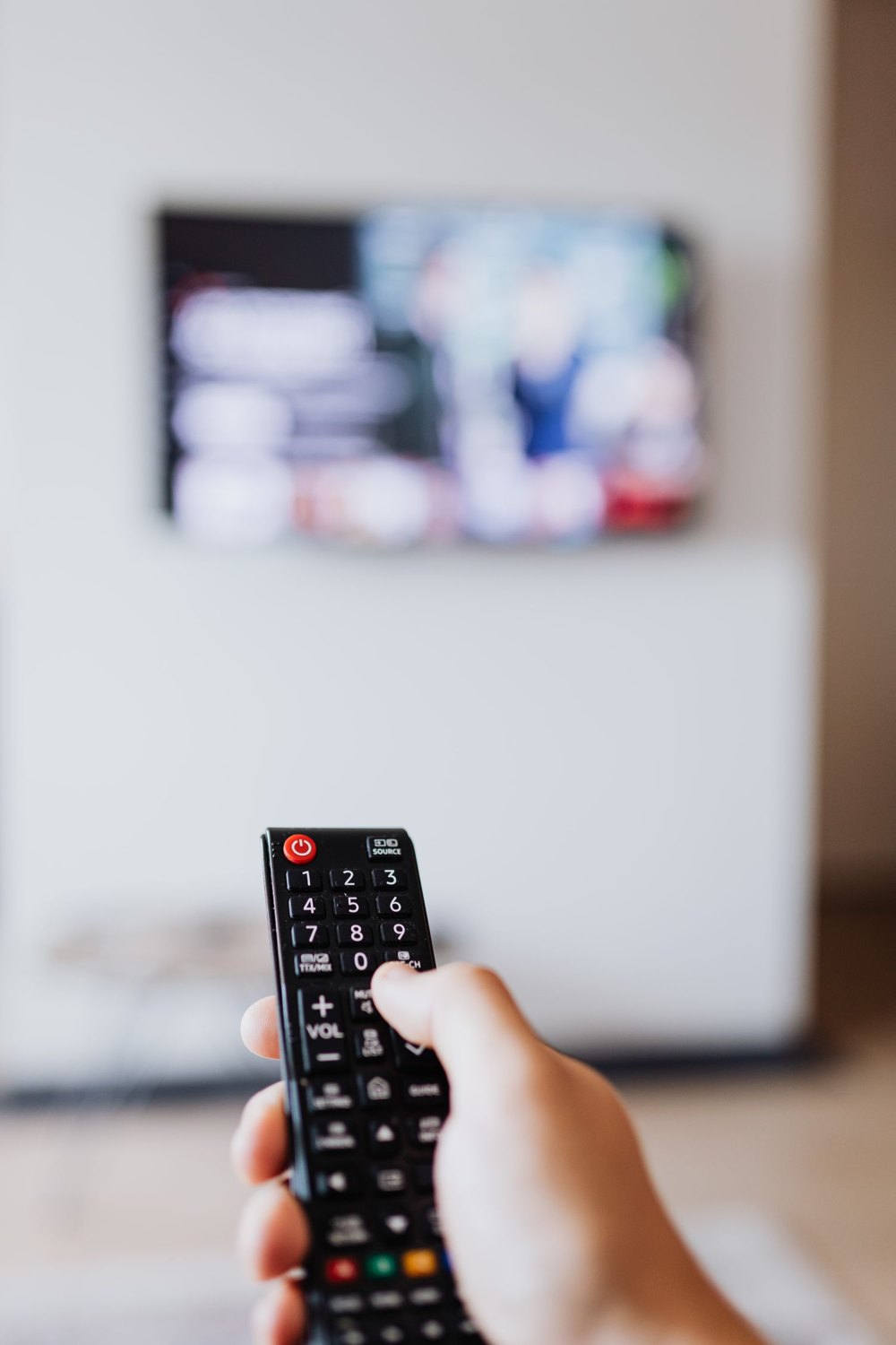 A remote control provides access to television settings.