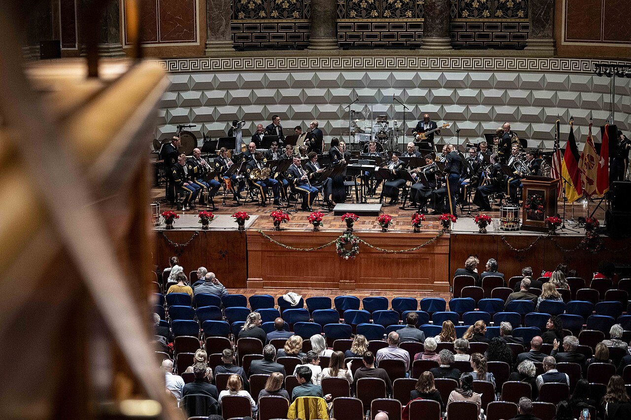 Seated audience in front of a concert stage.