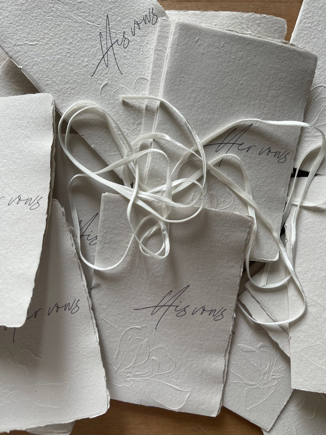 Printed invitations tied with ribbons.