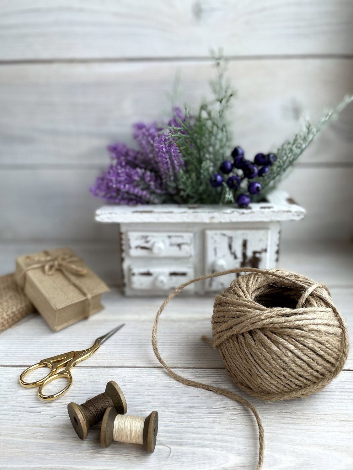 String, scissors and spools as materials available for crafting.